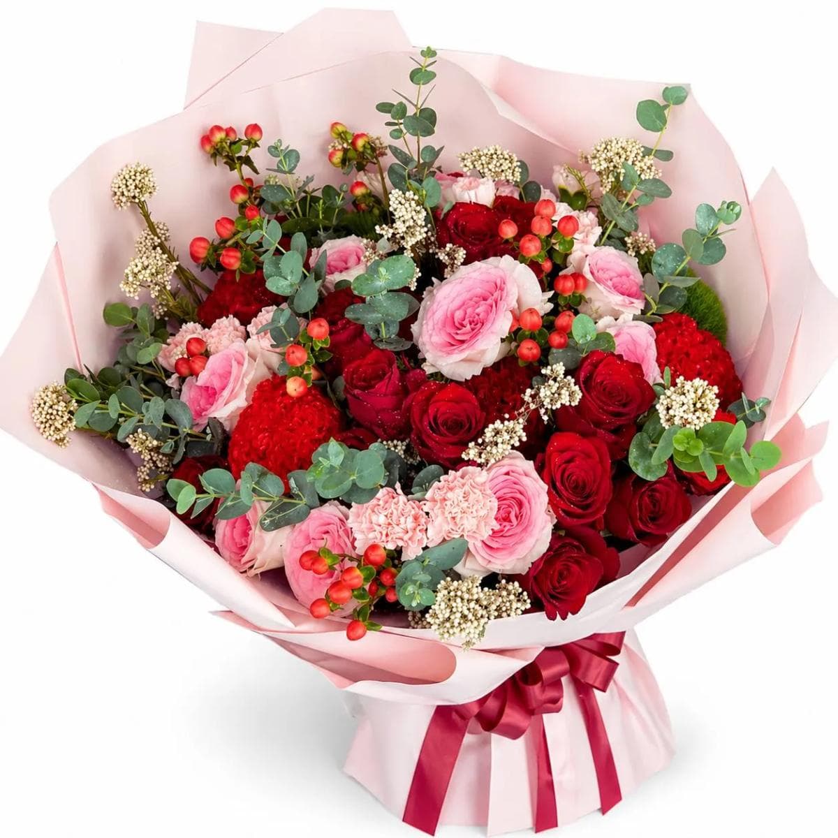 Express your deepest feelings with this elegant arrangement of premium crimson and blush pink roses. Accented with unique red celosia and ruffled carnations, this textured bouquet offers a sophisticated look for anniversaries or romantic surprises. Fresh eucalyptus and delicate white fillers add a natural touch, all beautifully presented in a soft pink wrap with a burgundy ribbon. It is a perfect choice for premium gifting in Chiang Mai.