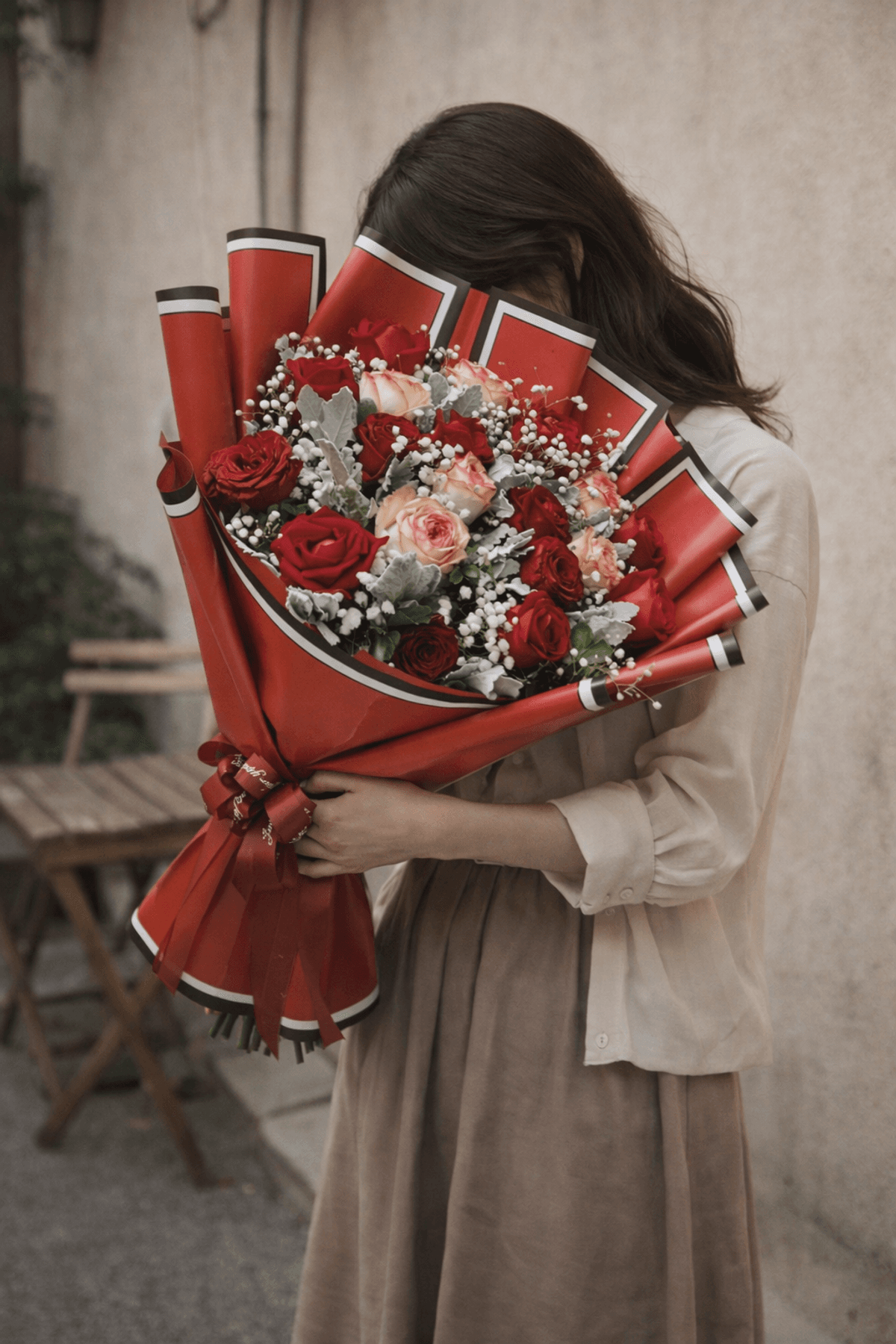 A bold and romantic rose bouquet arranged in a rounded hand-tied style. Rich, full, and beautifully textured with delicate baby’s breath and signature greenery. Perfect for anniversaries, birthdays, celebrations, or a grand romantic gesture—classic, elegant, and unforgettable.