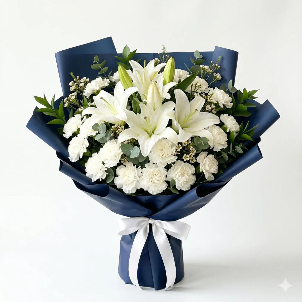 45cm flower bouquet with 4 white lilies and 15 white carnations in sophisticated navy blue matte wrapping, designed for weddings, corporate gifting, and elegant occasions in Chiang Mai.