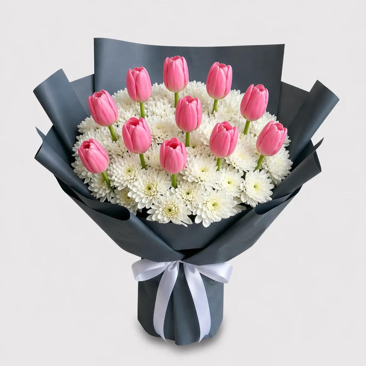 35cm flower bouquet with 8 Pink tulips and 10 white mums in matte black wrapping, designed for statement gifting, modern style, and bold floral presentation in Chiang Mai.