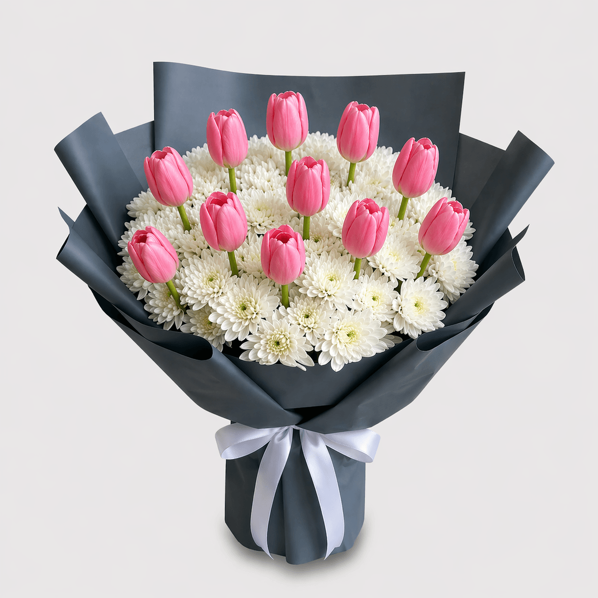35cm flower bouquet with 8 Pink tulips and 10 white mums in matte black wrapping, designed for statement gifting, modern style, and bold floral presentation in Chiang Mai.