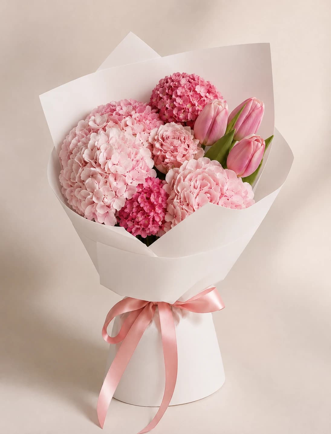 Pink Hydrangea and Tulip Bouquet with Hydrangeas, Tulips, wrapped in white paper with a pink ribbon.