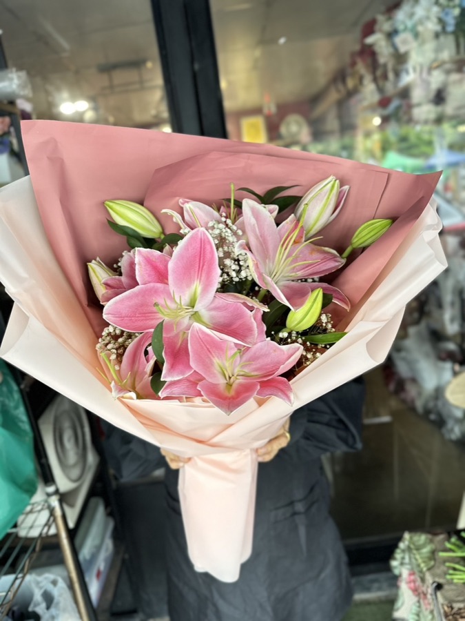 Pink lily bouquet with baby's breath wrapped in soft pink paper for Chiang Mai flower delivery